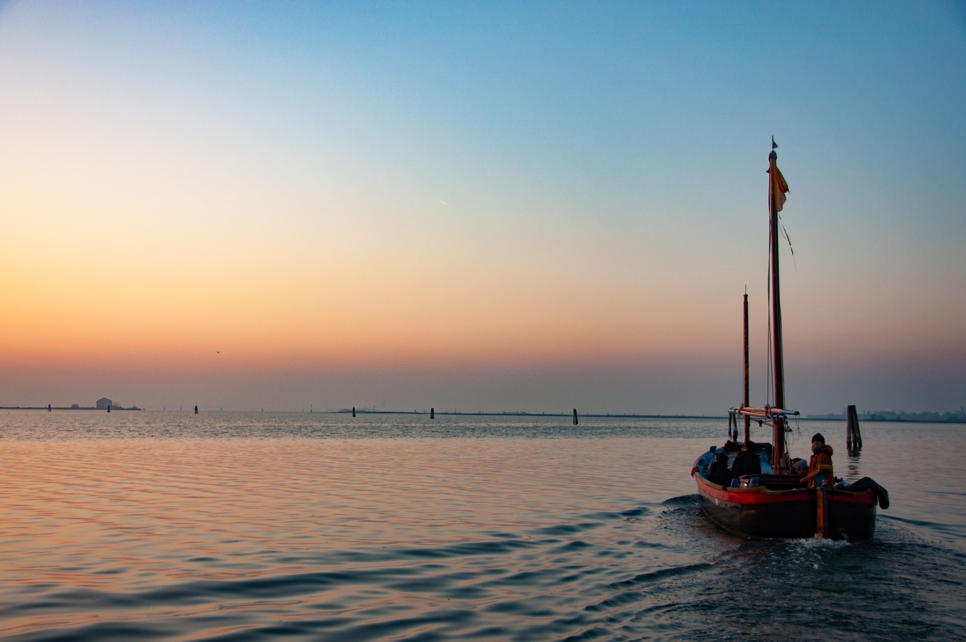 Bragosso boat sailing at golden hour on the Venice lagoon